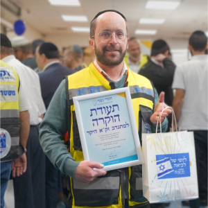 ZAKA Volunteer with care package and certificate of gratitude