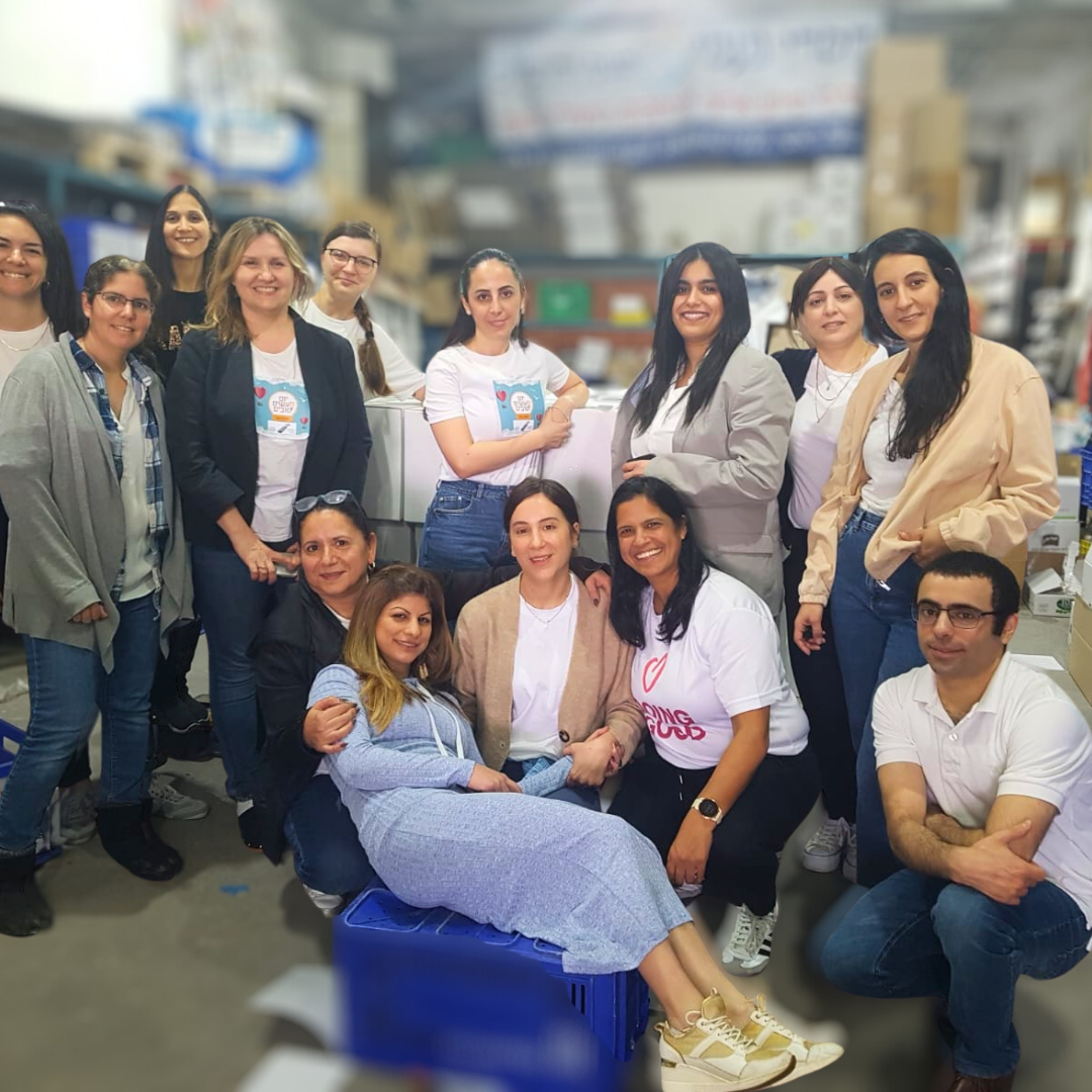 between Chasdei Naomi and the Council for Higher Education in Jerusalem as volunteers pack food care packages for Holocaust survivors, soldiers, and families in need.